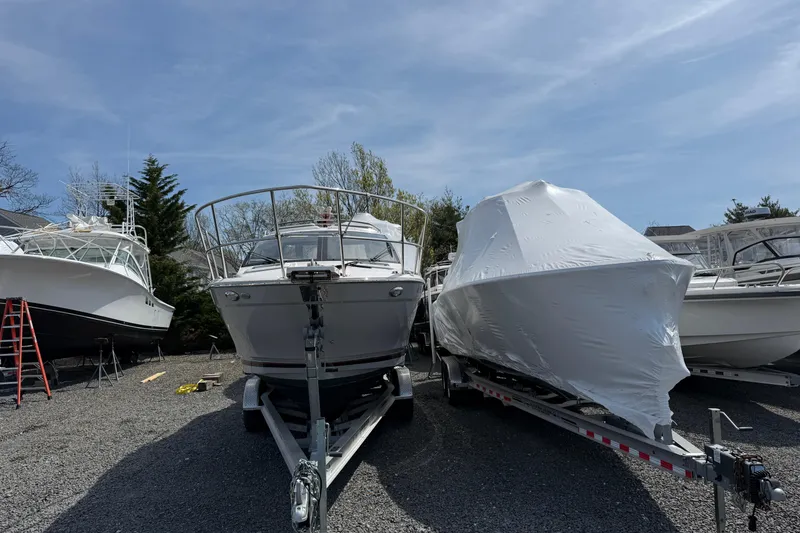 Slide: The Image of Boats on trailers, including a covered 2024 Solara S-250 Coupe, parked outdoors. - 3