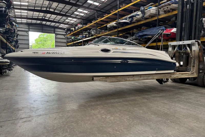 The Image of 2007 Sea Ray 240 Sundeck boat in storage facility, elevated on forklift. - 0