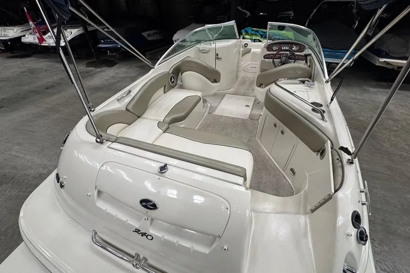 Slide: The Image of 2007 Sea Ray 240 Sundeck boat interior with seating and dashboard in a showroom. - 10