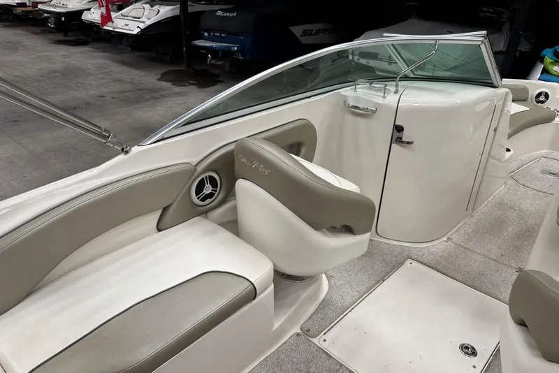 Slide: The Image of 2007 Sea Ray 240 Sundeck interior with beige seating and sleek design. - 12