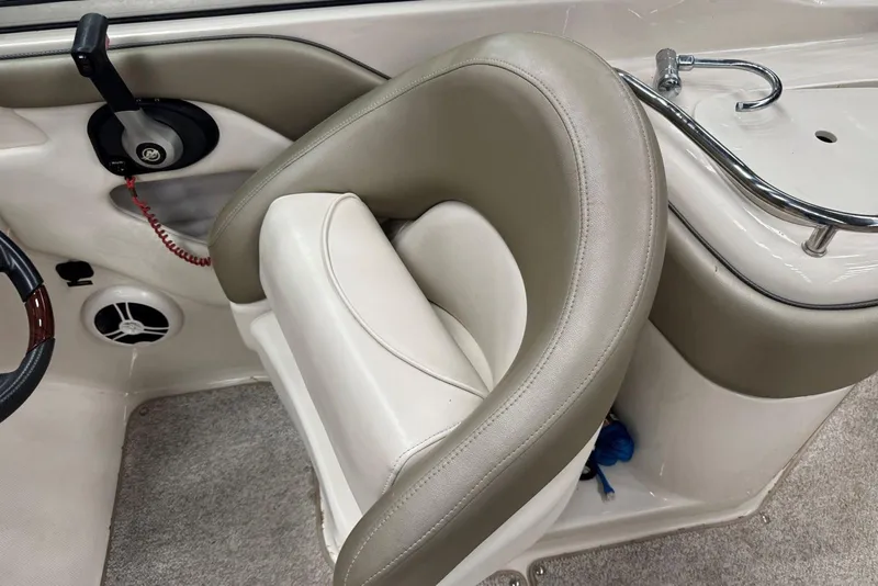 Slide: The Image of 2007 Sea Ray 240 Sundeck interior with beige seating and control panel. - 15
