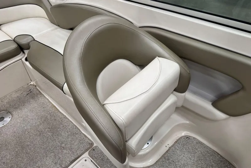 Slide: The Image of 2007 Sea Ray 240 Sundeck interior seating with beige and white upholstery. - 17