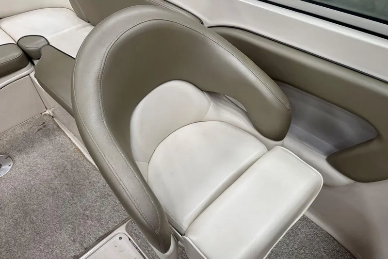Slide: The Image of 2007 Sea Ray 240 Sundeck interior seating with beige and white upholstery. - 18