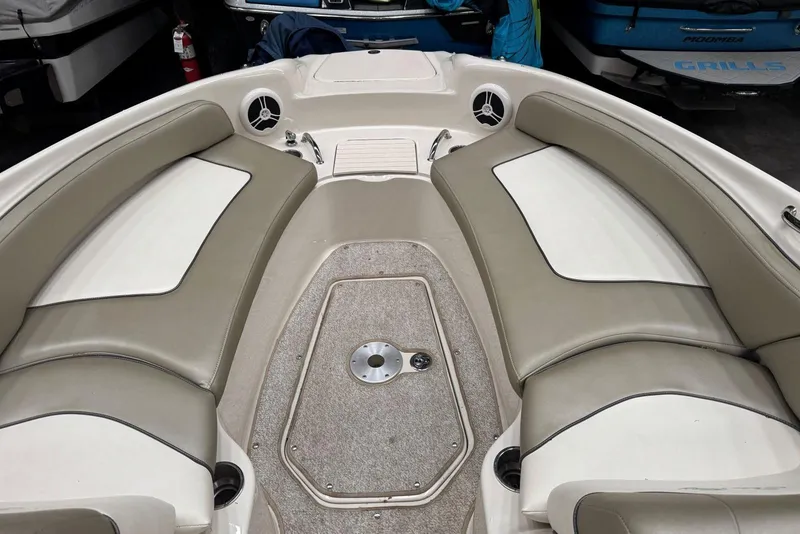 Slide: The Image of Interior view of a 2007 Sea Ray 240 Sundeck boat with beige seating. - 27