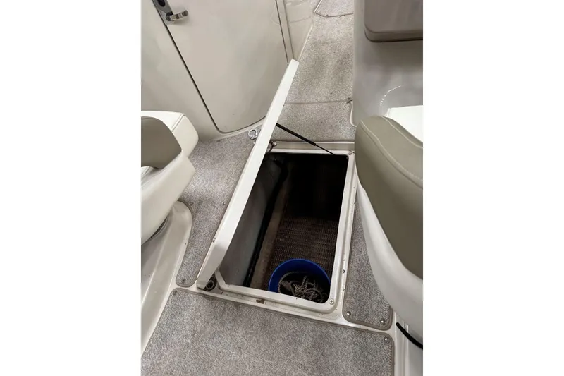 Slide: The Image of Open storage compartment on 2007 Sea Ray 240 Sundeck boat interior. - 28