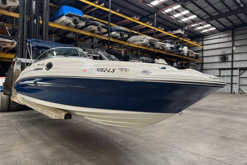 Slide: The Image of 2007 Sea Ray 240 Sundeck boat in storage facility, elevated on forklift. - 3
