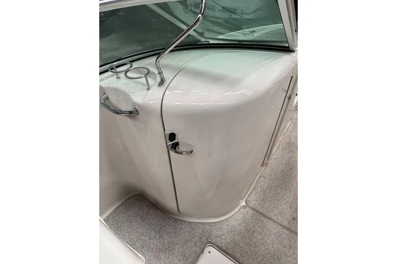 Slide: The Image of 2007 Sea Ray 240 Sundeck interior with windshield and cup holders. - 32