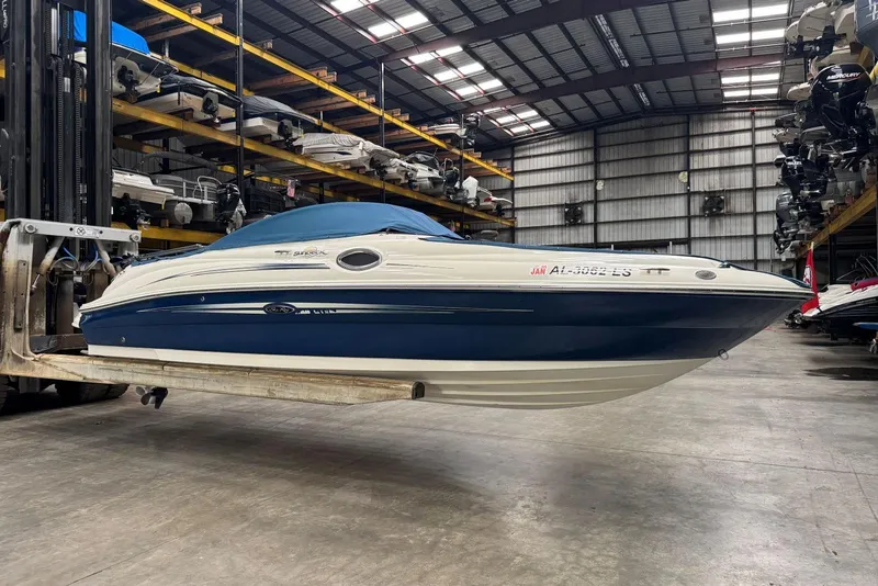 Slide: The Image of 2007 Sea Ray 240 Sundeck boat in storage facility, elevated by forklift. - 34