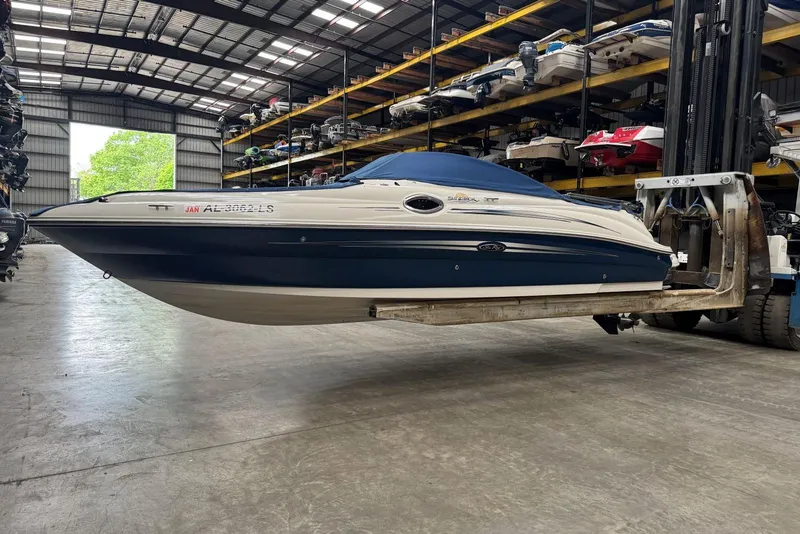Slide: The Image of 2007 Sea Ray 240 Sundeck boat in storage facility, lifted by forklift. - 35