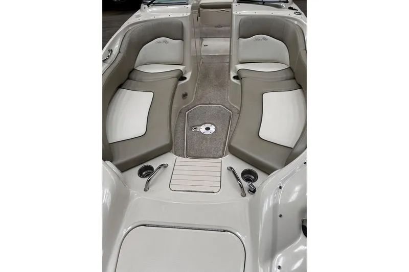 Slide: The Image of 2007 Sea Ray 240 Sundeck interior with cushioned seating and carpeted flooring. - 7