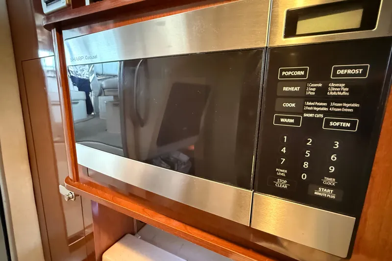 Slide: The Image of Microwave in 2010 Sea Ray Sundancer 280 yacht interior, featuring wood cabinetry. - 10