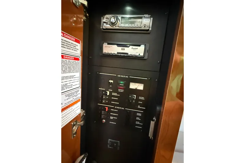 Slide: The Image of Control panel of a 2010 Sea Ray Sundancer 280 boat with stereo system and warning labels. - 13
