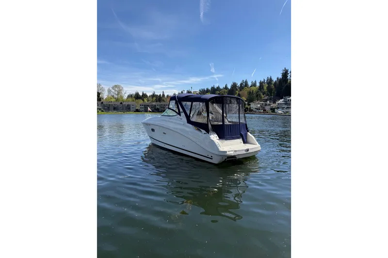 Slide: The Image of 2010 Sea Ray Sundancer 280 boat on a calm lake with scenic background. - 18