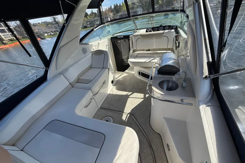 Slide: The Image of Interior of a 2010 Sea Ray Sundancer 280 boat with seating and kitchenette. - 19