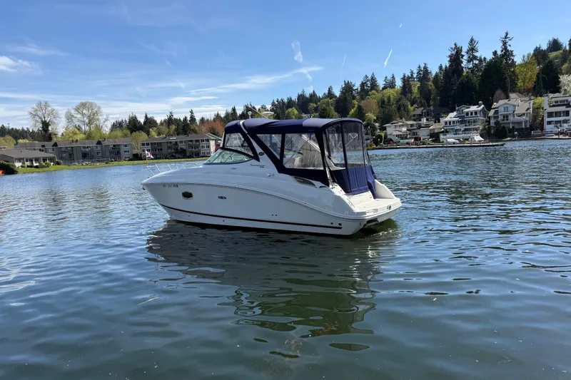 Slide: The Image of 2010 Sea Ray Sundancer 280 boat on a calm lake with scenic shoreline. - 2