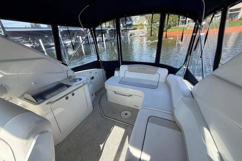 Slide: The Image of Interior of 2010 Sea Ray Sundancer 280 boat with white seating and kitchenette. - 20