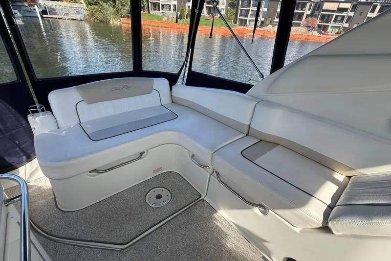 Slide: The Image of Interior seating of 2010 Sea Ray Sundancer 280 yacht, featuring white cushioned seats. - 22