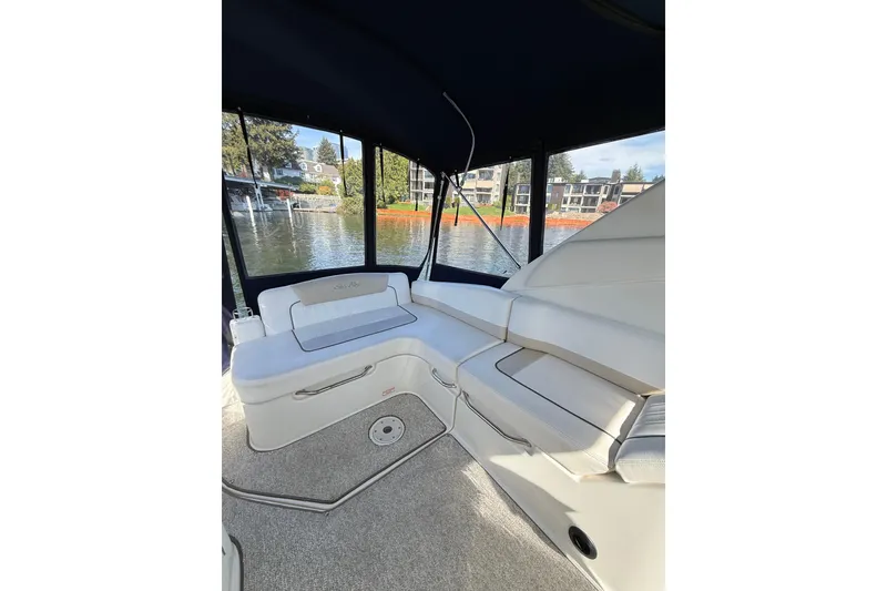 Slide: The Image of Interior view of 2010 Sea Ray Sundancer 280 boat with waterfront backdrop. - 23