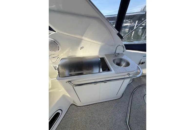 Slide: The Image of 2010 Sea Ray Sundancer 280 boat kitchenette with sink and grill. - 26