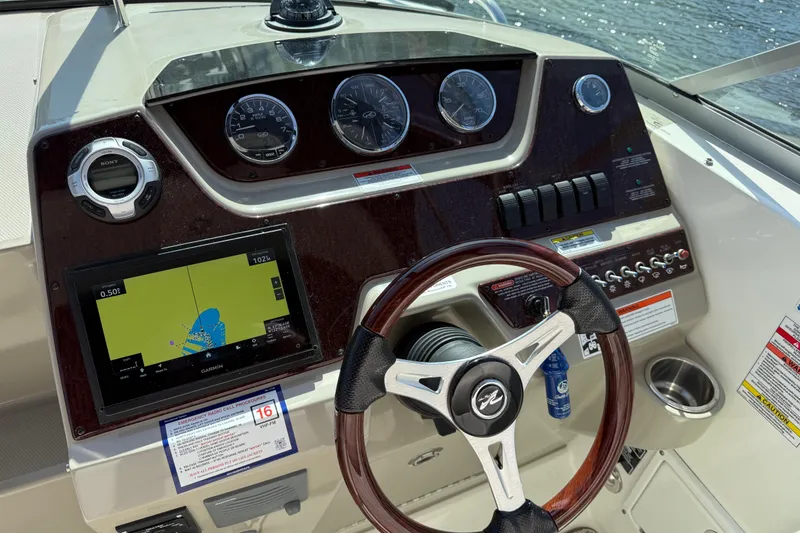 Slide: The Image of Dashboard of a 2010 Sea Ray Sundancer 280 with navigation and control instruments. - 28