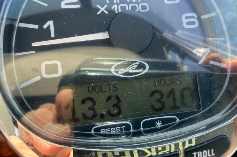 Slide: The Image of Close-up of Sea Ray Sundancer 280 gauge showing 13.3 volts and 310 hours. - 31