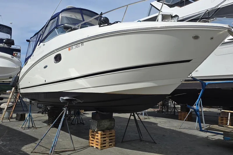Slide: The Image of 2010 Sea Ray Sundancer 280 yacht on dry dock, supported by stands. - 33