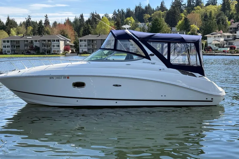 Slide: The Image of 2010 Sea Ray Sundancer 280 boat on a lake with residential backdrop. - 5