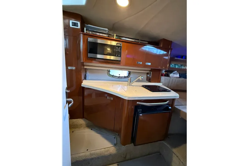 Slide: The Image of Interior of 2010 Sea Ray Sundancer 280 yacht with kitchenette, microwave, and sink. - 7