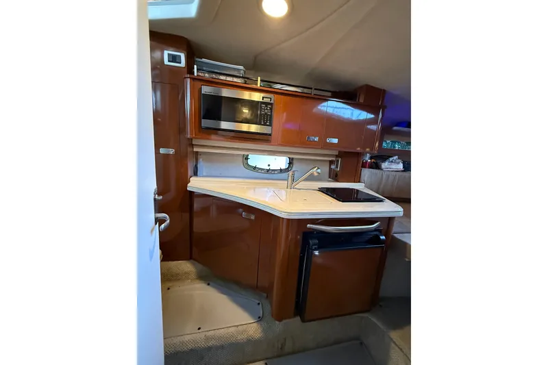 Slide: The Image of Interior of 2010 Sea Ray Sundancer 280 yacht kitchen with microwave, sink, and compact fridge. - 8