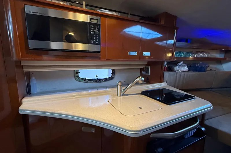 Slide: The Image of Interior of 2010 Sea Ray Sundancer 280 with kitchenette, microwave, and sink. - 9
