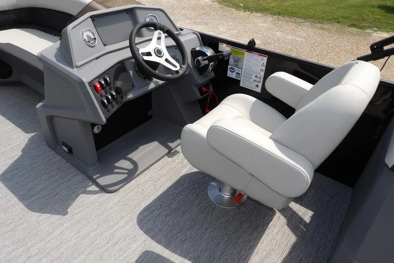 Slide: The Image of Captain's seat and helm of 2026 Sylvan R-22 LZ DH boat, featuring modern controls. - 17