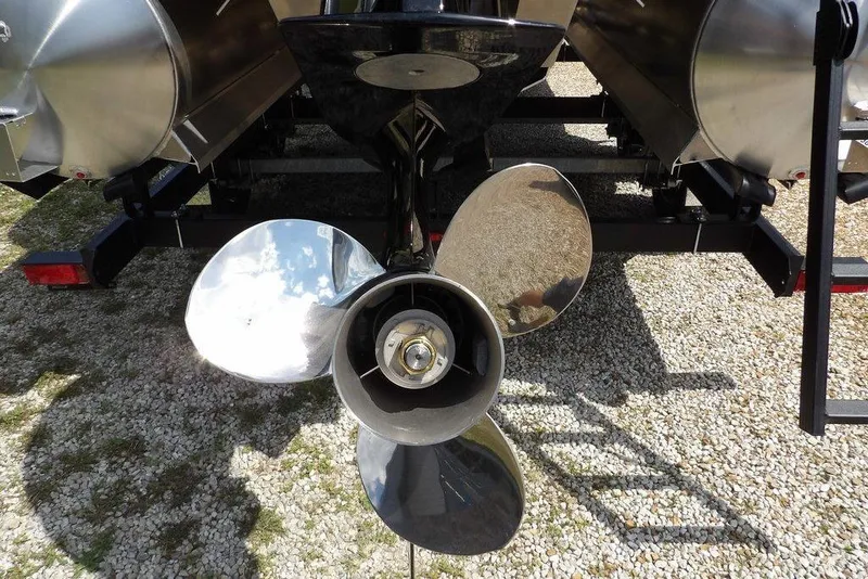 Slide: The Image of Propeller of 2026 Sylvan R-22 LZ DH pontoon boat on gravel surface. - 21