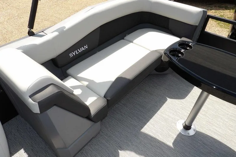 Slide: The Image of Luxurious seating on 2026 Sylvan R-22 LZ DH pontoon boat with sleek black table. - 25