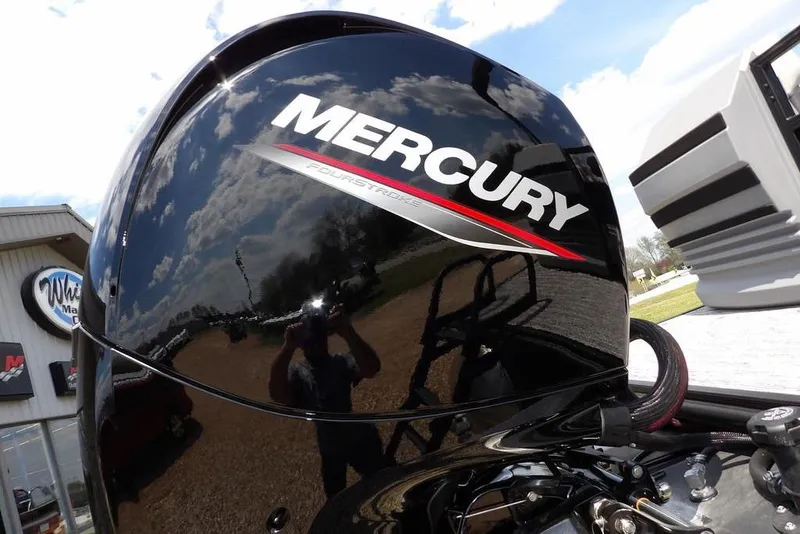 Slide: The Image of Mercury FourStroke engine on a 2026 Sylvan R-22 LZ DH boat, reflecting sky and surroundings. - 31