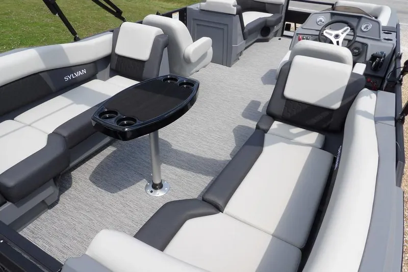 Slide: The Image of Luxurious interior of 2026 Sylvan R-22 LZ DH pontoon boat with plush seating and table. - 32