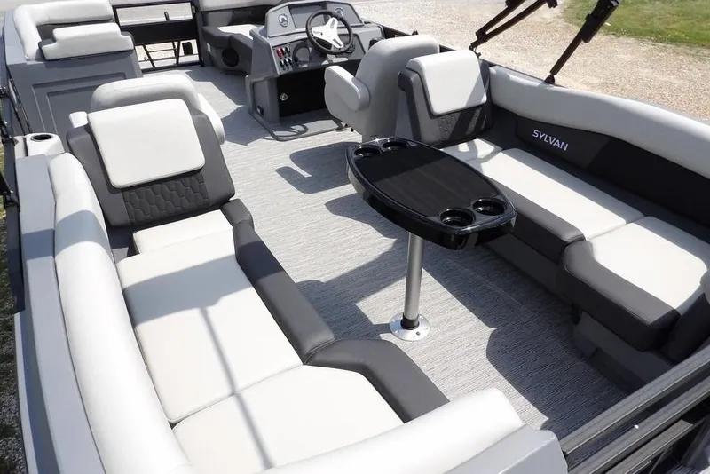 Slide: The Image of Luxurious interior of 2026 Sylvan R-22 LZ DH pontoon boat with plush seating and table. - 33