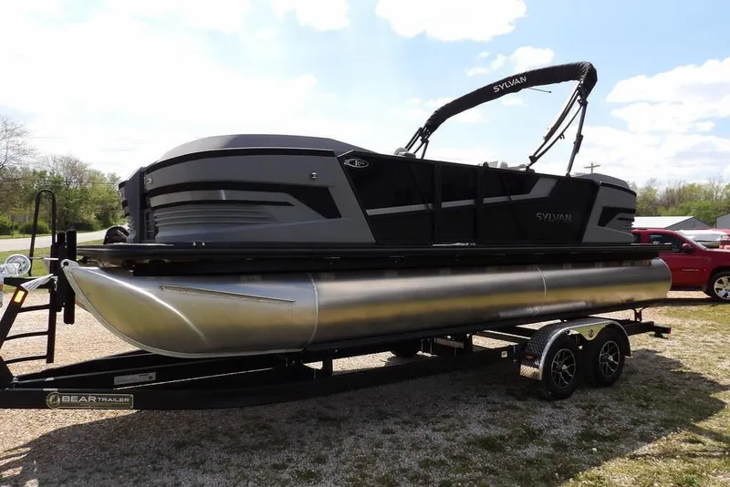 Slide: The Image of 2026 Sylvan R-22 LZ DH pontoon boat on trailer, parked outdoors. - 4