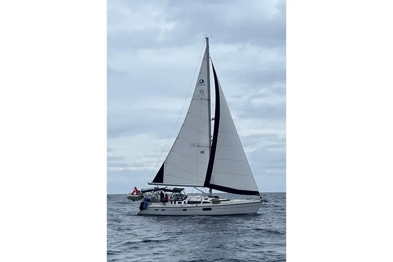 The Image of Sailing yacht Hunter 410, 2002 model, cruising on open sea under cloudy skies. - 0