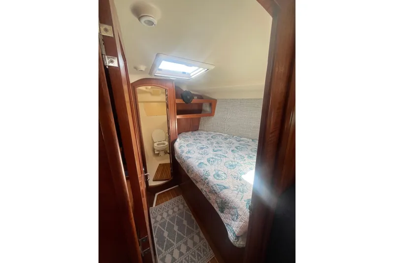 Slide: The Image of Cozy cabin interior of 2002 Hunter 410 sailboat with bed and bathroom. - 14