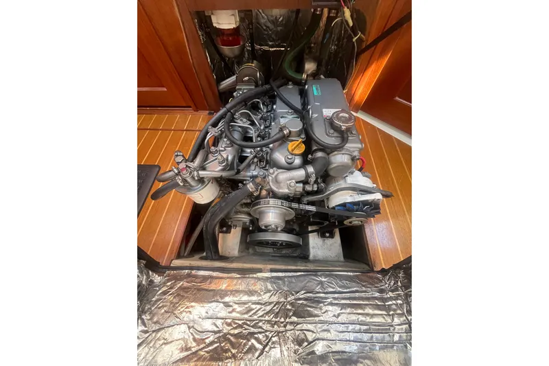 Slide: The Image of Engine compartment of a 2002 Hunter 410 sailboat, showcasing detailed mechanical components. - 15