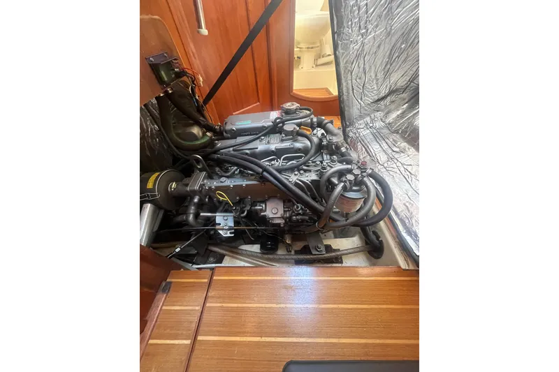 Slide: The Image of Engine compartment of a 2002 Hunter 410 sailboat, showcasing detailed mechanical components. - 16
