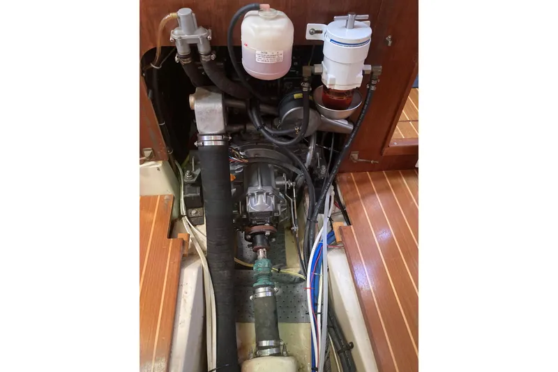 Slide: The Image of Engine compartment of a 2002 Hunter 410 sailboat, showing hoses and filters. - 17