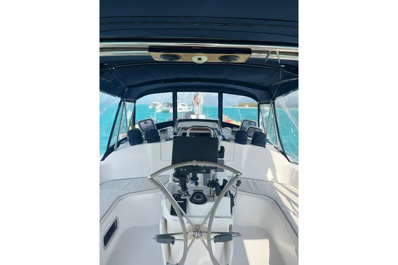 Slide: The Image of Interior view of a 2002 Hunter 410 sailboat cockpit with steering wheel and navigation equipment. - 21