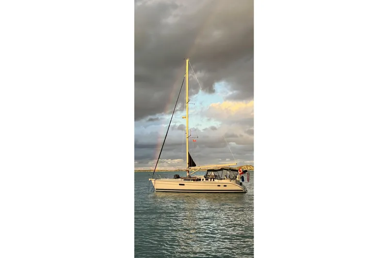 Slide: The Image of Sailboat Hunter 410 (2002) on calm water under cloudy sky. - 24