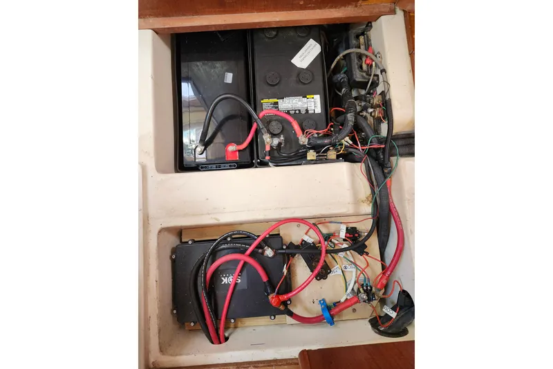 Slide: The Image of Electrical system of a 2002 Hunter 410 boat, featuring batteries and wiring. - 26
