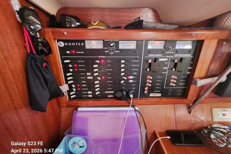 Slide: The Image of Electrical panel of a 2002 Hunter 410 sailboat with various switches and gauges. - 27