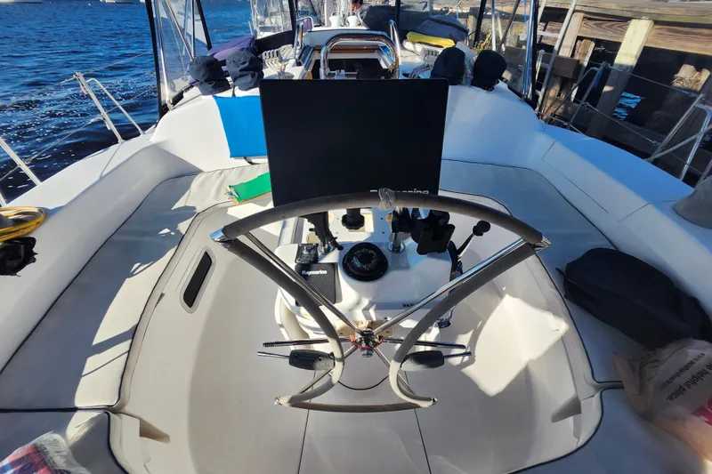 Slide: The Image of Cockpit of a 2002 Hunter 410 sailboat with steering wheel and navigation equipment. - 28