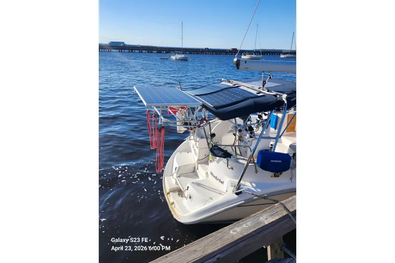 Slide: The Image of Sailboat docked with solar panels, Hunter 410 model, 2002, on a sunny day. - 29