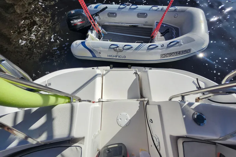Slide: The Image of View from a 2002 Hunter 410 sailboat, showing a Highfield inflatable boat with Suzuki motor. - 31