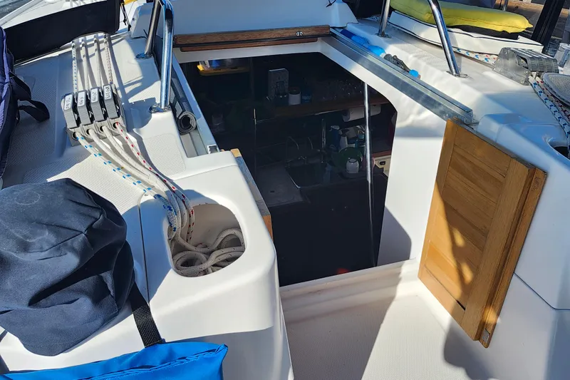 Slide: The Image of Cockpit view of a 2002 Hunter 410 sailboat, showing ropes and cabin entrance. - 32